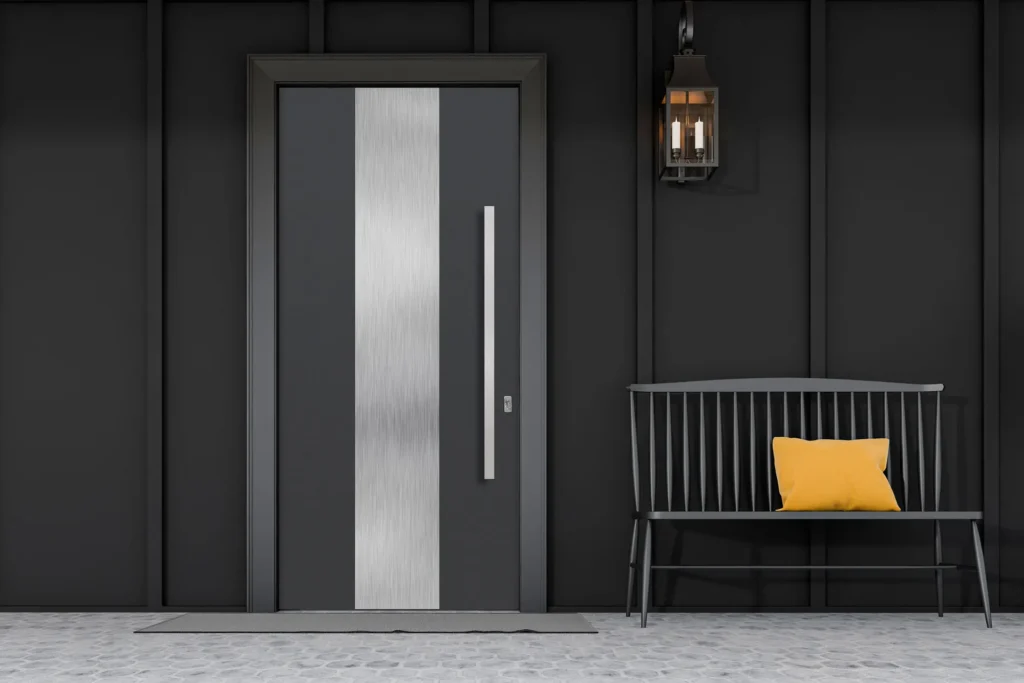 A modern black door with a silver stripe, beside a gray bench and yellow pillow.